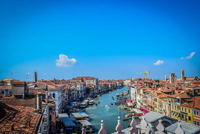 High angle view of harbor by buildings against sky