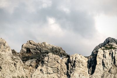 Scenic view of rock formations against cloudy sky