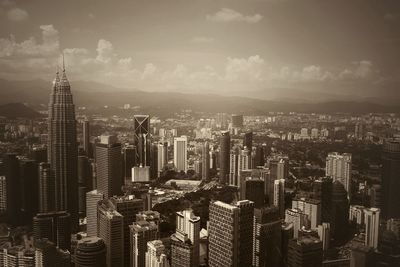 Skyscrapers against cloudy sky