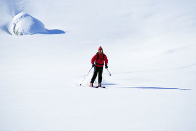 Man with umbrella on snowy land