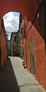 Narrow alley amidst buildings against sky