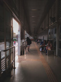 People walking in corridor of building