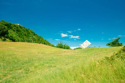 Scenic view of field against blue sky