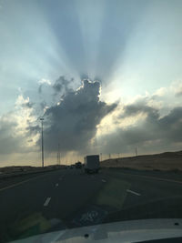 Road against sky seen through car windshield