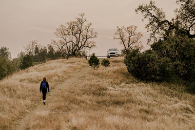 Female hiker walking back to car in hills of big sur