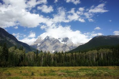 Scenic view of mountain range against cloudy sky