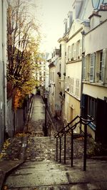 Alley amidst houses in city