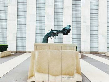 Man statue against building in city