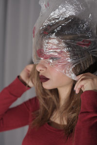 Portrait of women covered with plastic bag full of kisses 