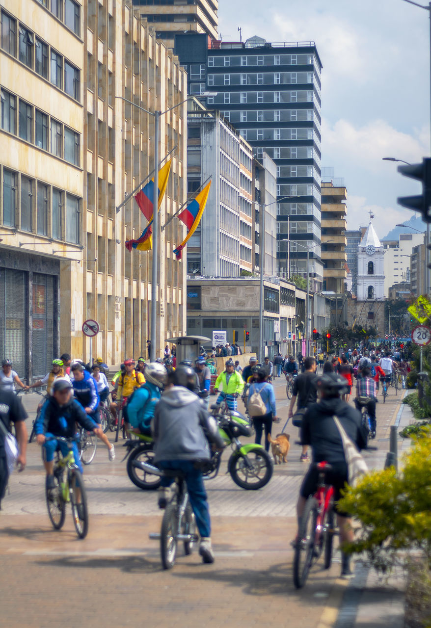 PEOPLE RIDING BICYCLE ON CITY STREET