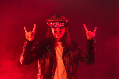 Portrait of man standing against red background