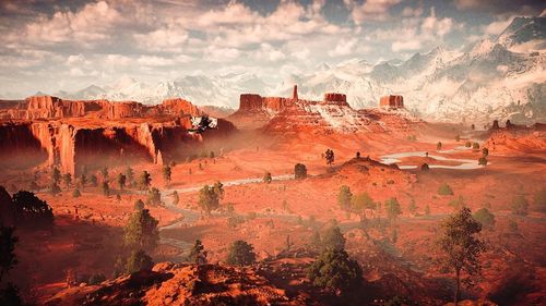 Panoramic view of rock formations against cloudy sky