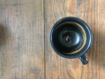 High angle view of coffee cup on wooden table