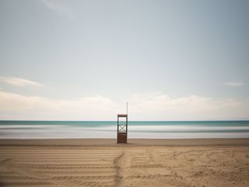 Lifeguard hut on beach against sky