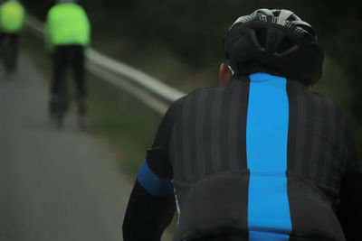 Rear view of man standing against railing