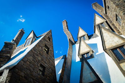 Low angle view of buildings against blue sky