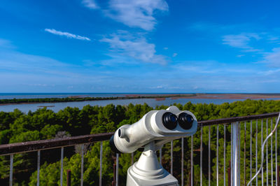 Rear view of man photographing sea against sky