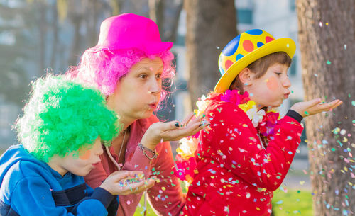 Woman and children playing with confetti during event