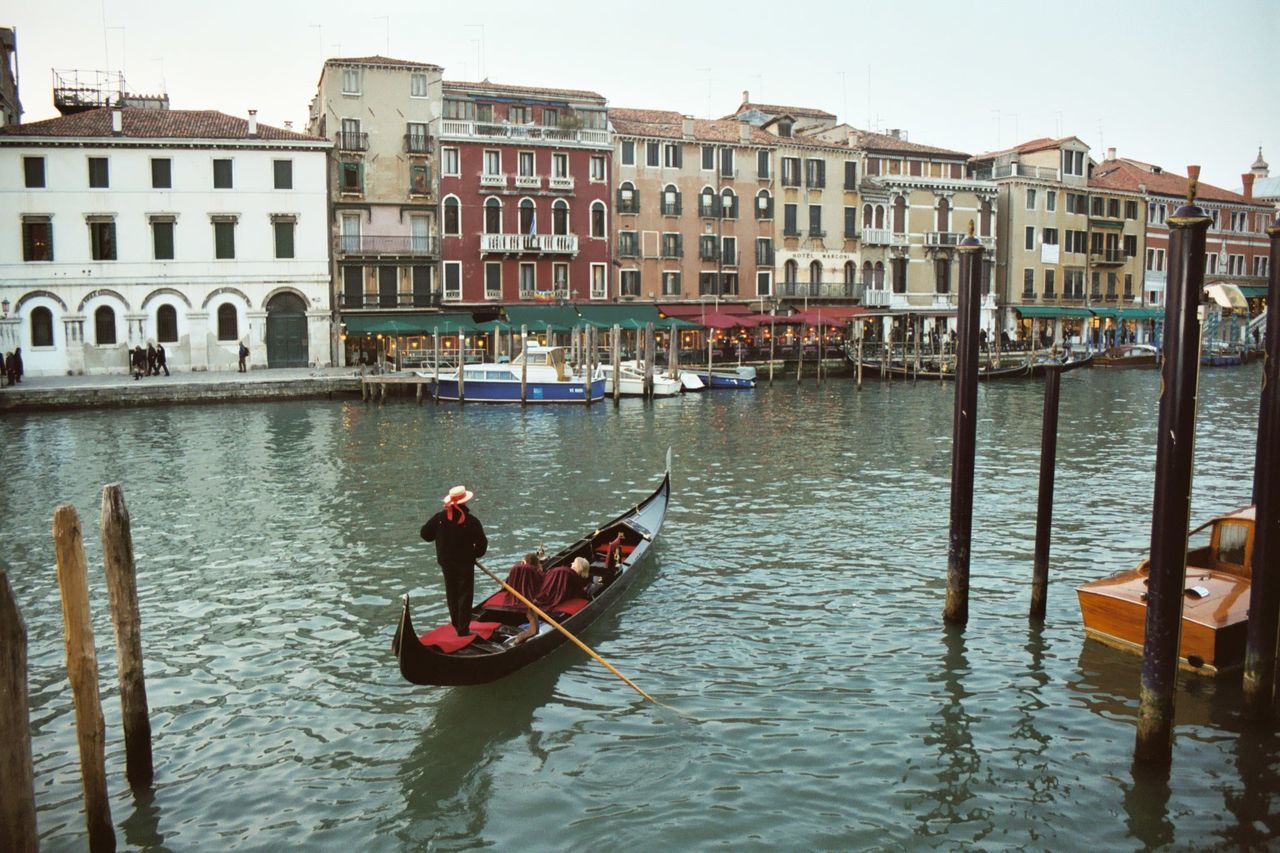 MAN ROWING BOAT IN CANAL