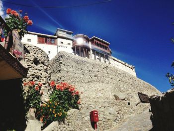 Low angle view of buildings against blue sky