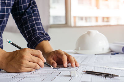 Midsection of man working on table