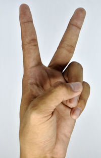 Close-up of human hand against white background