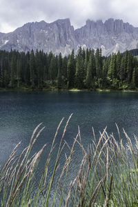 Scenic view of lake by mountains against sky