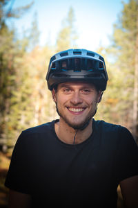 Candid portrait of a young athlete with a real smile and mud on his face. autumn colors