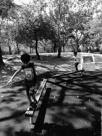 Rear view of boy on road