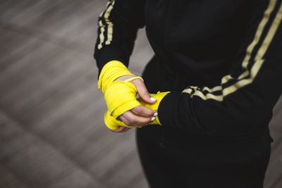 Midsection of woman wearing boxing strap outdoors