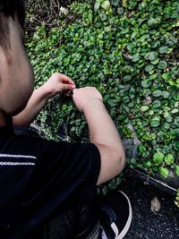 Midsection of child holding plant