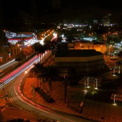 High angle view of illuminated cityscape against sky at night