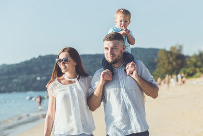 Portrait of father with son standing against the background