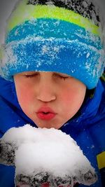 Close-up portrait of boy in snow