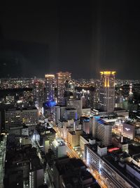 High angle view of illuminated buildings in city at night