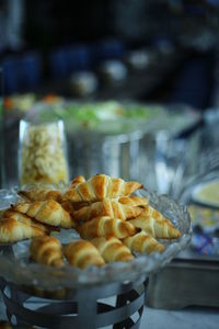 Close-up of fresh croissants in glass bowl during buffet at restaurant