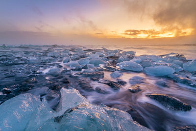 Aerial view of sea against sky during sunset