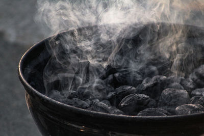 Close-up of smoke emitting from charcoal