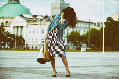 Woman standing against wall