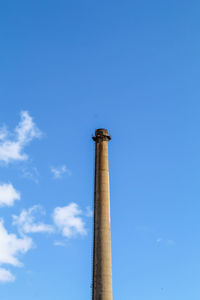 Low angle view of smoke stack against sky