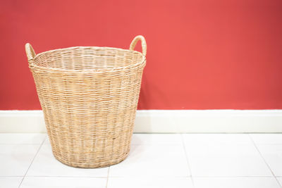 Close-up of basket on table against wall