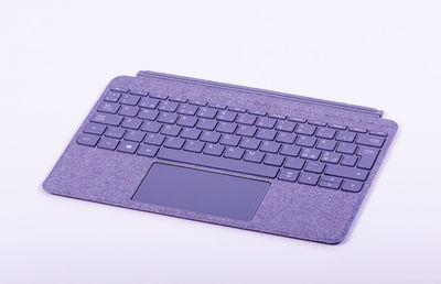 Low angle view of laptop keyboard against white background