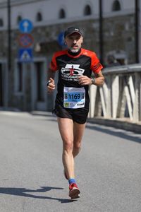 Portrait of man running on road