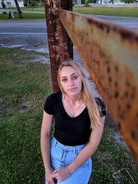 Portrait of beautiful young woman standing on land