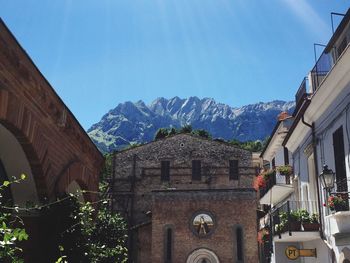 Low angle view of historic church against mountain