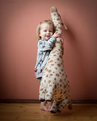 Portrait of cute girl standing on floor