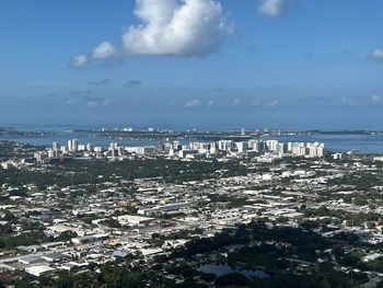 High angle view of townscape by sea against sky