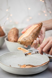 Close-up of hand holding ice cream in plate