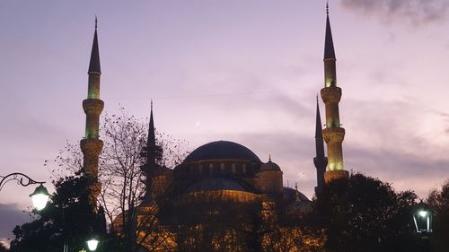 Low angle view of mosque tower against sky