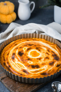 Ready-to-eat fresh sweet layered pumpkin pie in the form on the table. thanksgiving treat. 